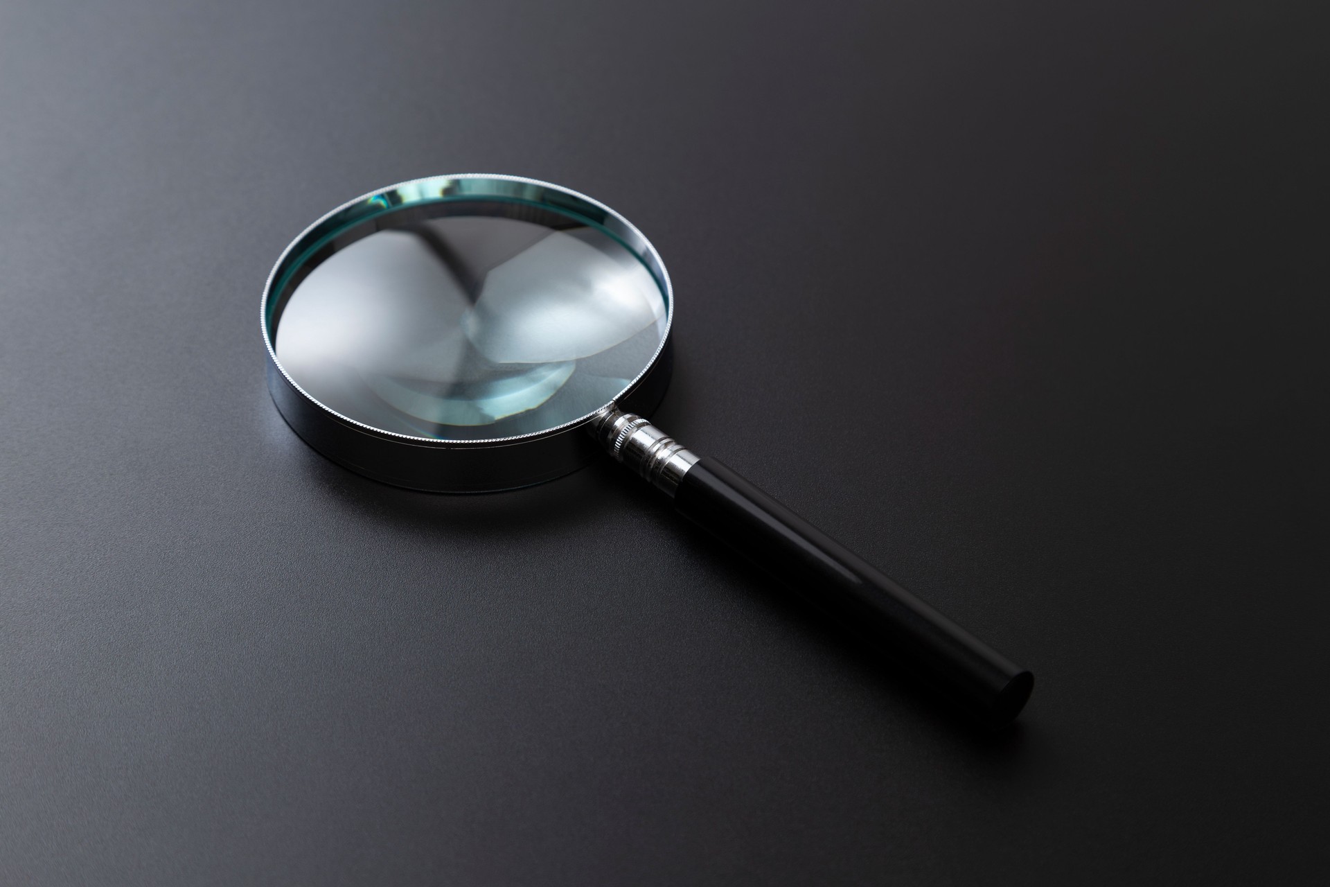 Magnifying glass on a black background.